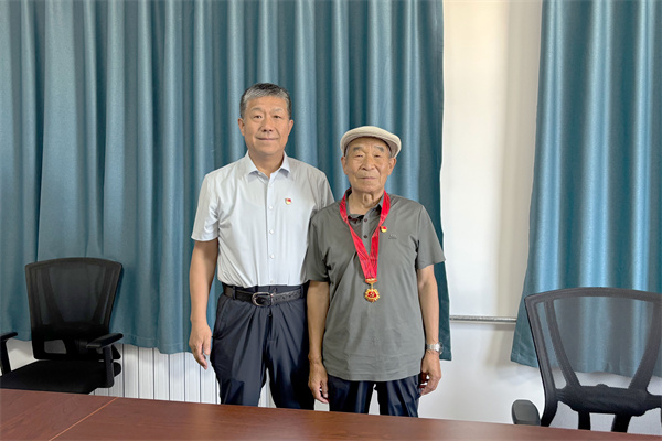 2吴继东为老党员秦汉有颁发“光荣在党50年”纪念章.jpg